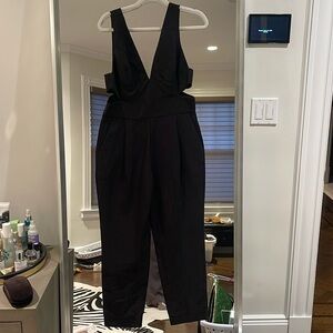 Bardot black jumpsuit with cut out sides so flattering says it’s a US size 6/s
